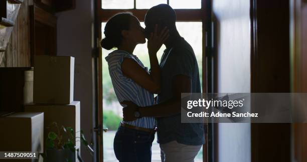 kiss, real estate and silhouette of couple at new house for celebration, affectionate and hugging. happiness, moving and mortgage with man and woman at front door for homeowner, relocation and love - black couples kissing stock pictures, royalty-free photos & images