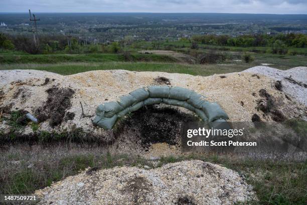 Disused Ukrainian trench overlooks a monastery town once occupied by Russian troops strive to restore normal life and unify their community, in...