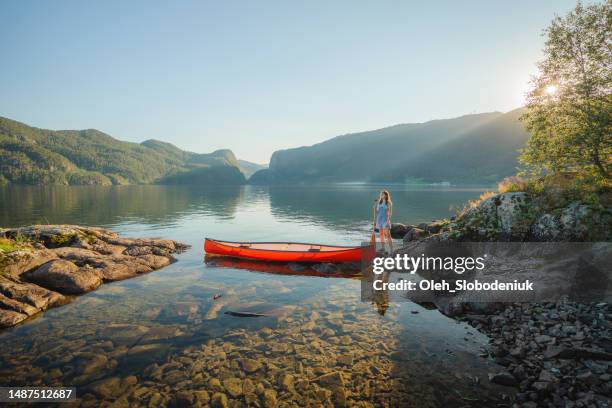 woman canoeing on the lake in norway - rowboat stock pictures, royalty-free photos & images