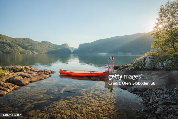 woman canoeing on the lake in norway - rowboat bildbanksfoton och bilder