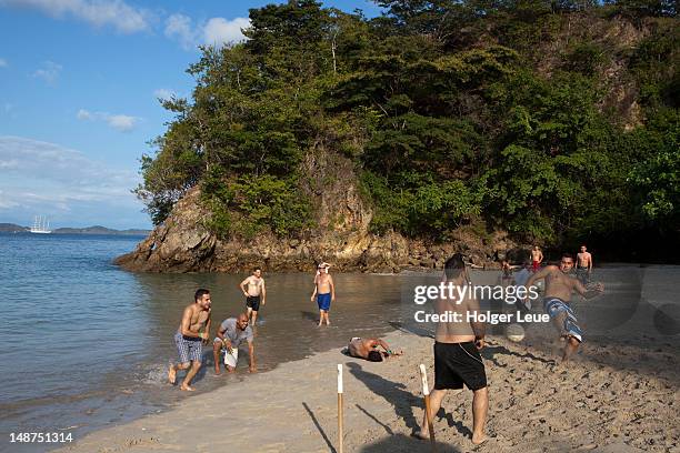 young men playing beach soccer. - beach football stock pictures, royalty-free photos & images