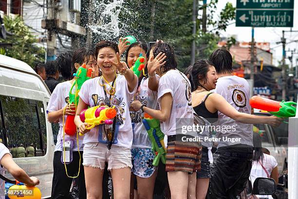 people with water cannons at songkran festival. - songkran stock pictures, royalty-free photos & images