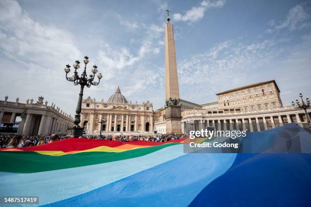 Children hold a rainbow flag as Pope Francis speaks to the crowd during his Angelus prayer from the window of the apostolic palace overlooking St...