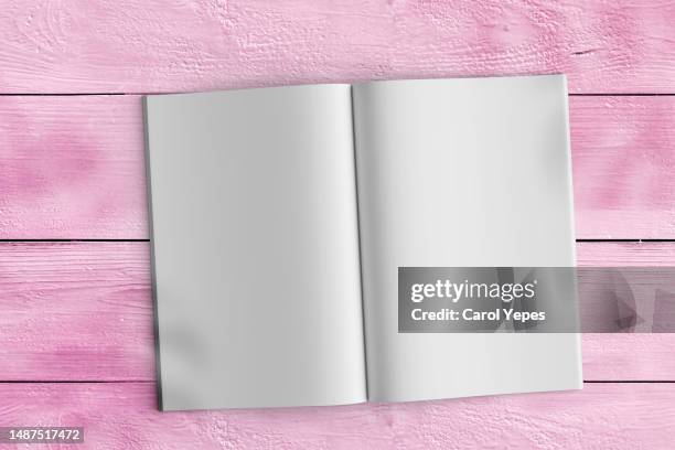 blank magazine page in pink concrete surface.blogger - blank pages in open book overhead view stock pictures, royalty-free photos & images
