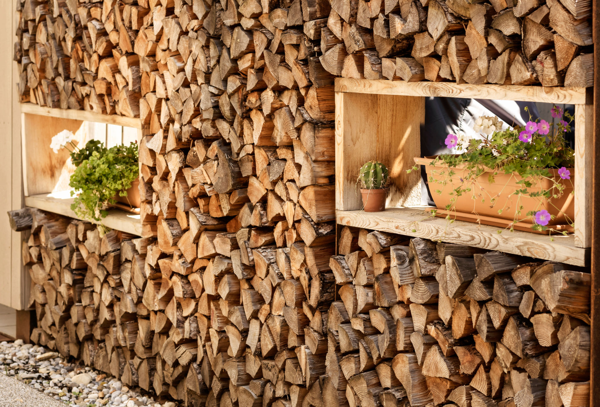Firewood Storage is decorated with Pots with Flowers Firewood Storage is decorated with Pots with Flowers