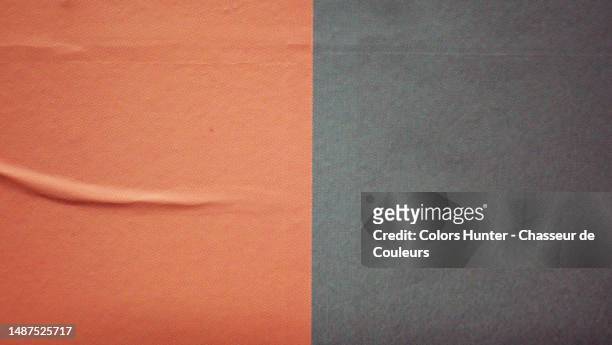 close-up of a poster pasted on a wall, wrinkled and printed using the offset technique in brown and gray in paris, france - news background stock pictures, royalty-free photos & images