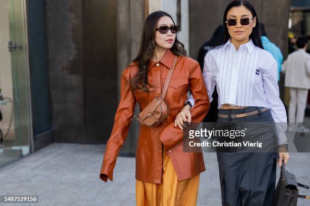 Guest wears brown Loewe bag, jacket, orange skirt & Aliya Bermukhambetova wears Hermes bag, white cropped Miu Miu button shirt, high waisted skirt,...