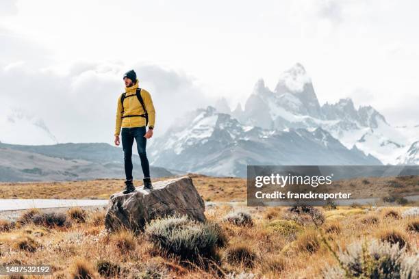 man resting on the rock in el chalten - santa cruz province argentina stock pictures, royalty-free photos & images