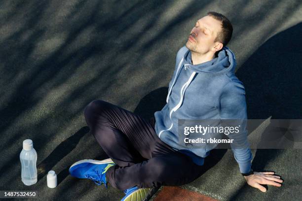 recovery of an athlete after training - break for rest - exhaling stock pictures, royalty-free photos & images