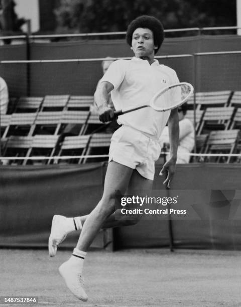 Jamaican tennis player Richard Russell plays a shot during his men's singles match against John James in the Rothmans Surrey Hard Court...