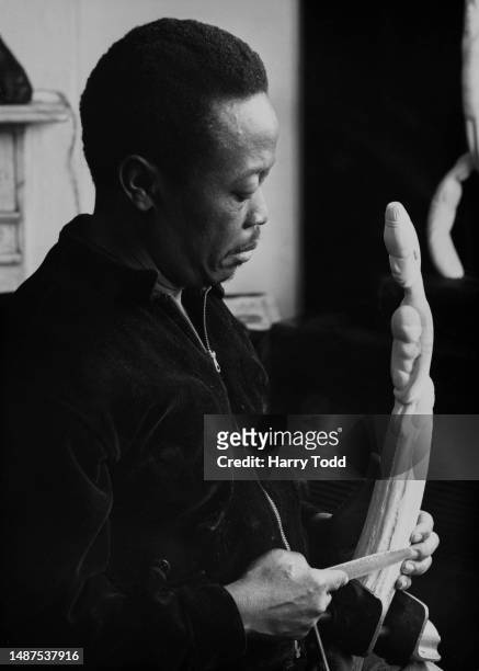 Jamaican artist and writer Namba Roy , working on an ivory statuette, London, February 21st 1958. The sculpture was a gift to Queen Elizabeth II to...