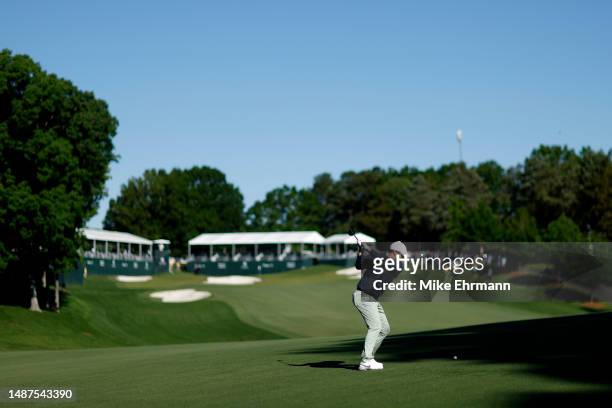 Rory McIlroy of Northern Ireland plays an approach shot on the 15th hole during the first round of the Wells Fargo Championship at Quail Hollow...