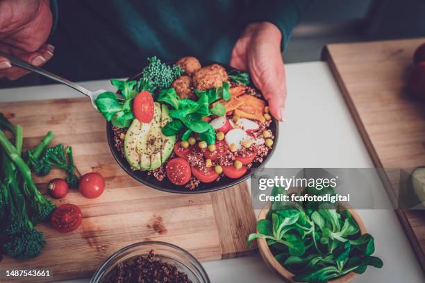 woman holding healthy salad plate and fork - quinoa stockfoto's en -beelden