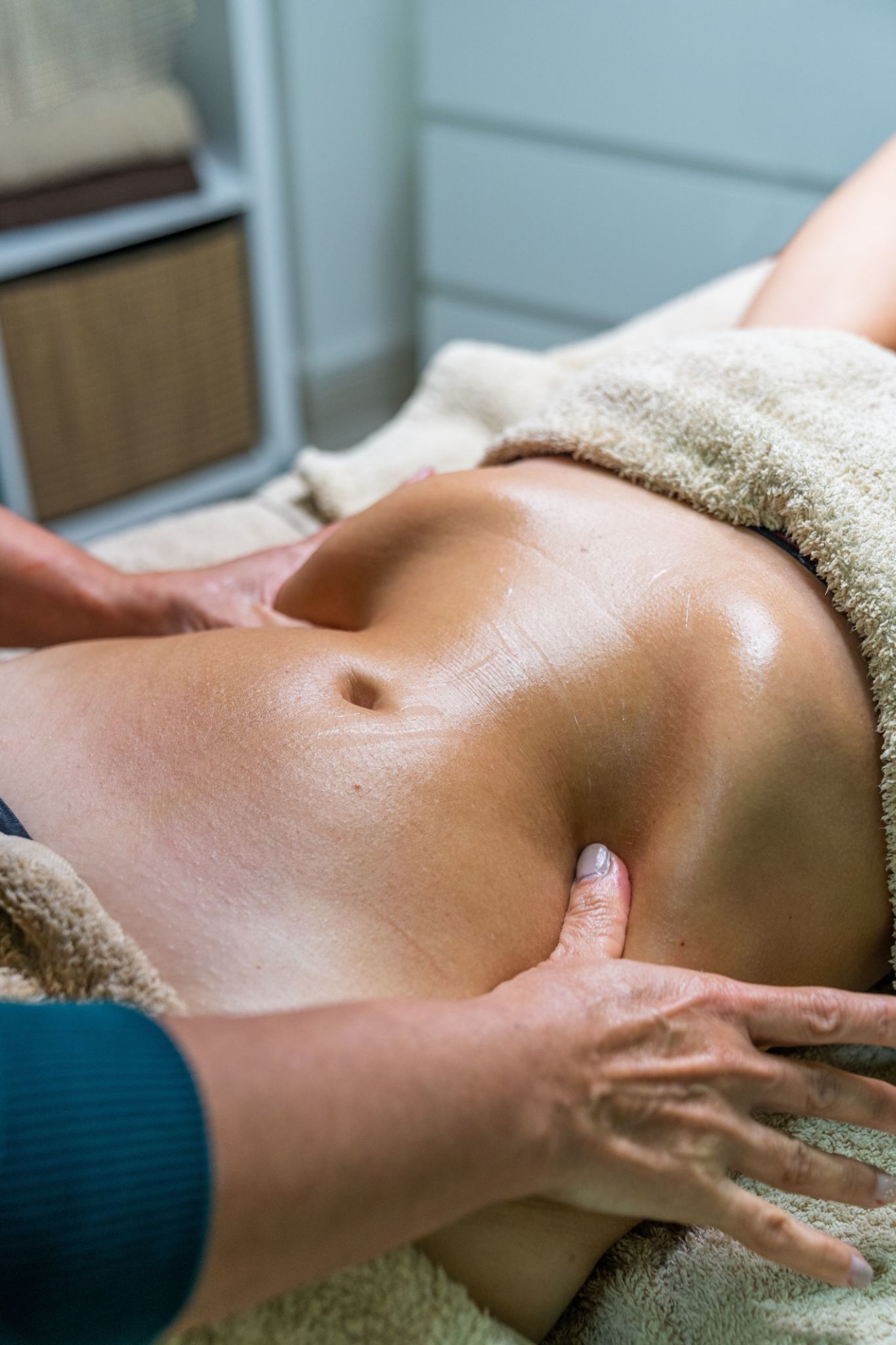 Hands of specialist performing lymphatic drainage massage on abdomen of female patient. Hands of specialist performing lymphatic drainage massage on abdomen of female patient.