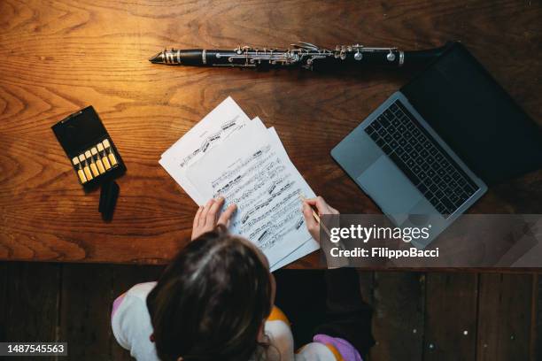 a clarinet player is studying sheet music using a laptop - working on laptop in train top view stock pictures, royalty-free photos & images