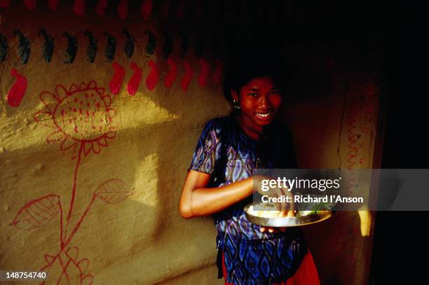 tharu girl eating lunch outside home in mainaha village. - nepal food stock pictures, royalty-free photos & images