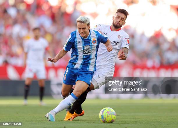 Denis Suarez of RCD Espanyol is challenged by Alex Telles of Sevilla FC during the LaLiga Santander match between Sevilla FC and RCD Espanyol at...