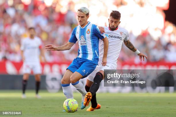 Denis Suarez of RCD Espanyol is challenged by Alex Telles of Sevilla FC during the LaLiga Santander match between Sevilla FC and RCD Espanyol at...