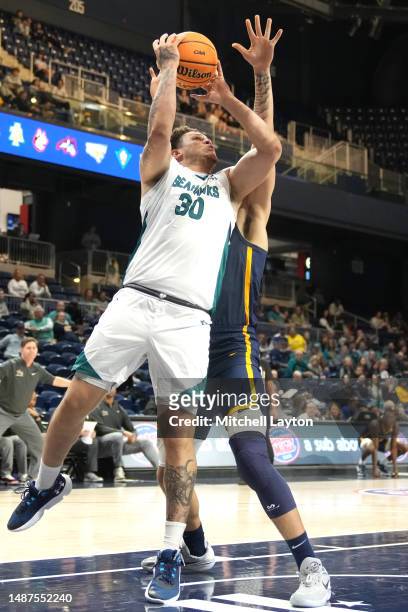 Nick Farrar of the North Carolina-Wilmington Seahawks drives to the basket during the CAA Men's Basketball Championship - quarterfinal game against...