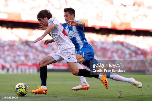 Bryan Gil of Sevilla FC runs with the ball whilst under pressure from Cesar Montes of RCD Espanyol during the LaLiga Santander match between Sevilla...