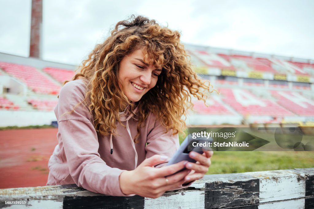 Portrait of a sportswoman with a phone