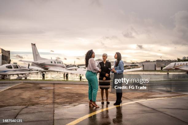coworkers talking in the airport hangar - latin america stock pictures, royalty-free photos & images