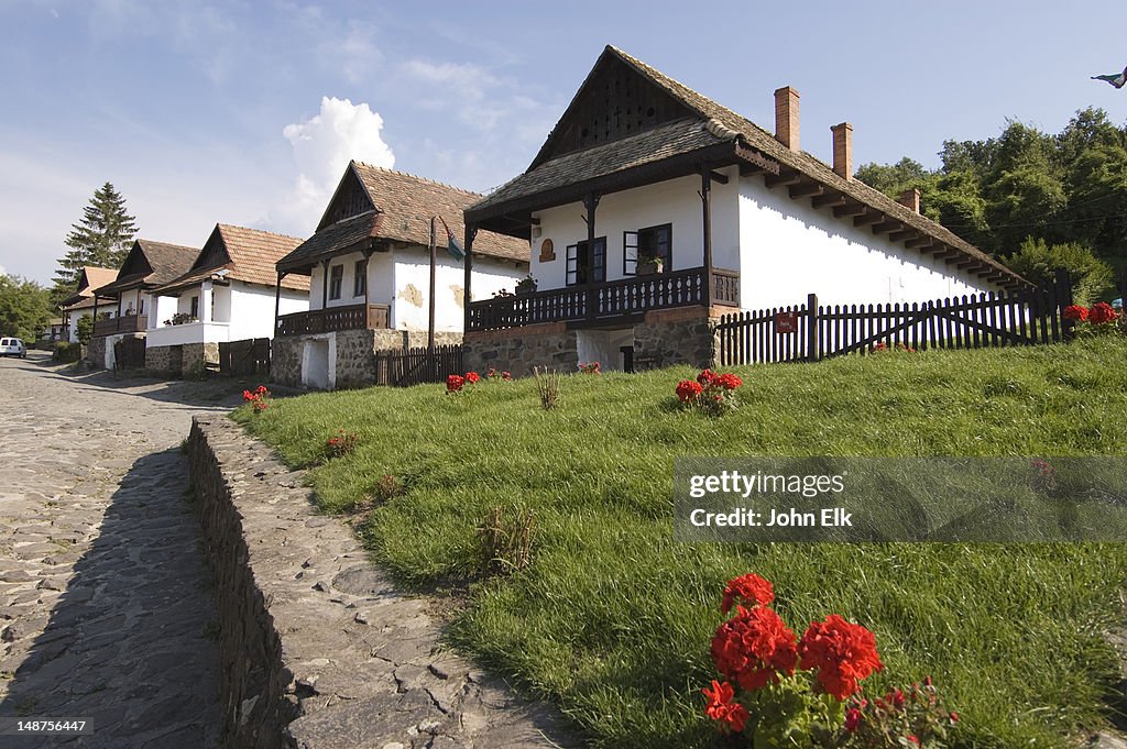 Traditional village with farmhouses and geraniums.