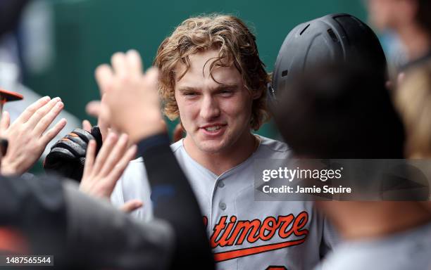 Gunnar Henderson of the Baltimore Orioles is congratulated by teammates in the dugout after hitting a home run during the 3rd inning of the game...