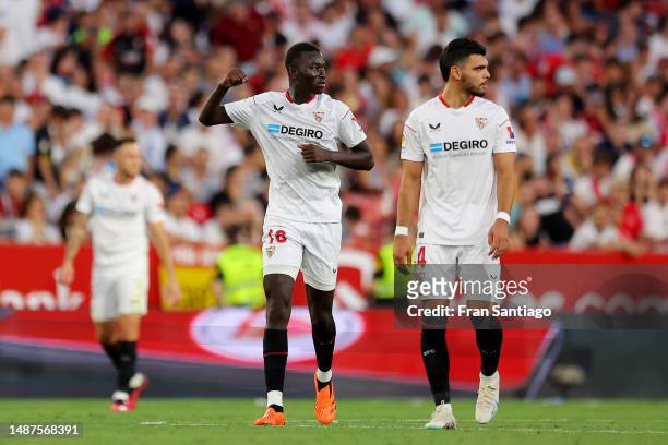 Pape Gueye of Sevilla FC celebrates alongside teammate Karim Rekik after scoring the team's third goal during the LaLiga Santander match between...
