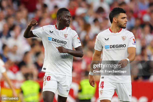 Pape Gueye of Sevilla FC celebrates alongside teammate Karim Rekik after scoring the team's third goal during the LaLiga Santander match between...