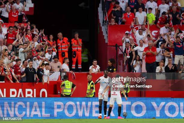 Pape Gueye of Sevilla FC celebrates alongside teammate Marcos Acuna after scoring the team's third goal during the LaLiga Santander match between...