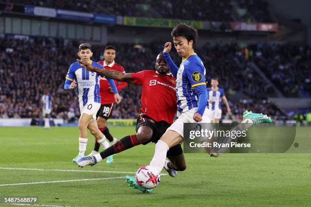 Kaoru Mitoma of Brighton & Hove Albion shoots whilst under pressure from Aaron Wan-Bissaka of Manchester United during the Premier League match...