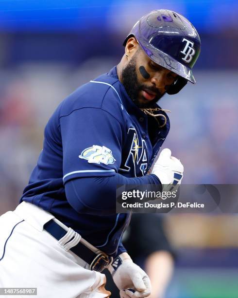 Yandy Diaz of the Tampa Bay Rays reacts after hitting a solo home run during the eighth inning against the Pittsburgh Pirates at Tropicana Field on...