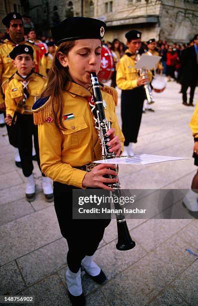 girl playing an instrument in a palestinian scout christmas procession. - palestinian boy stock pictures, royalty-free photos & images