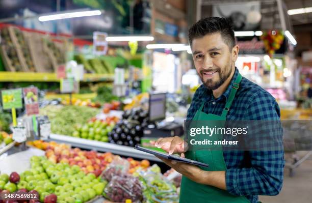 happy retail clerk working at the supermarket - merchant stock pictures, royalty-free photos & images