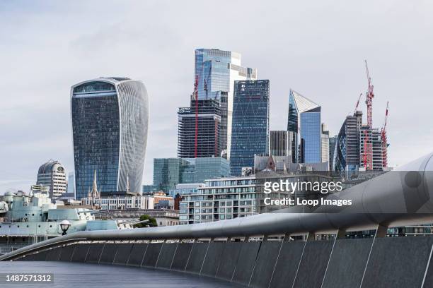 The Square Mile of London's financial district pictured over a curve around The Scoop on the London waterfront.