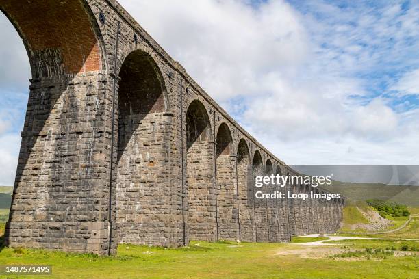 Looking up at the Ribblehead Viaduct under a bright sky pictured in the Yorkshire Dales.