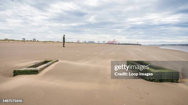 An Iron Man on a windy Crosby beach near Liverpool.