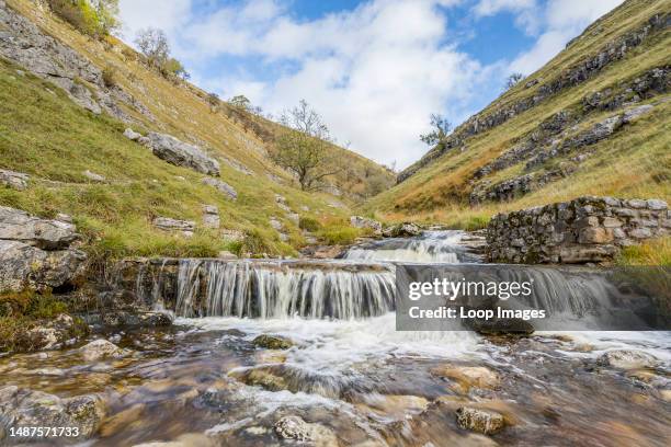 Water flowing over the cascades and small waterfalls along Bucken Beck in the Upper Wharfedale area of Yorkshire.