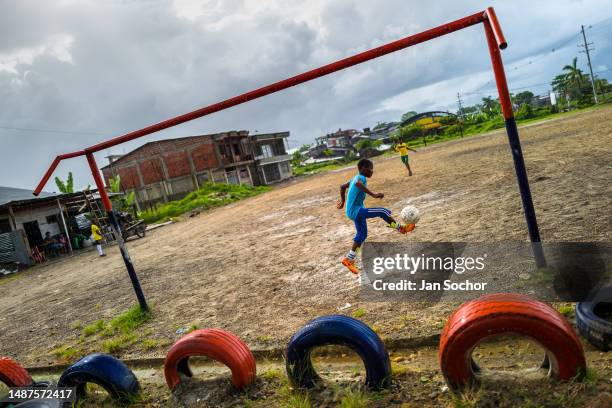 Afro-Colombian boys play the ball during a football training session on a dirt playing field on October 8, 2019 in Quibdó, Chocó, Colombia. Young...