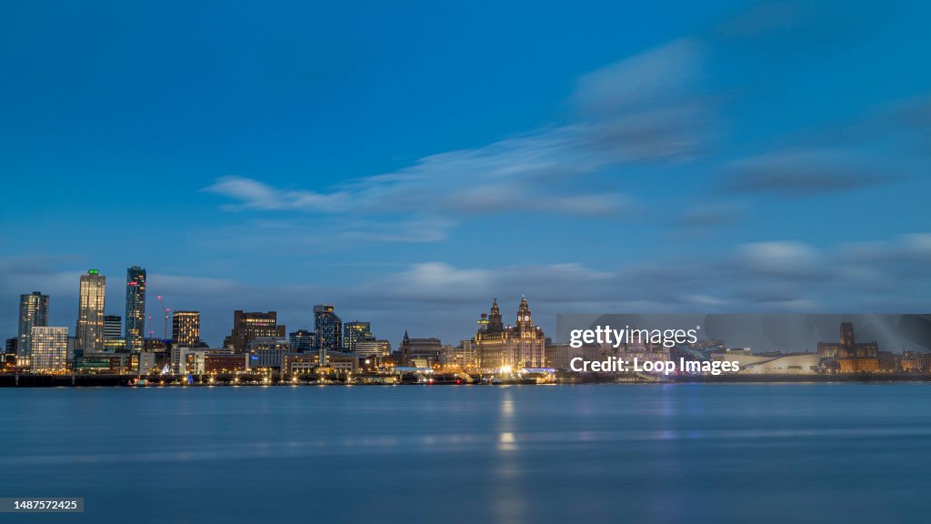 The Liverpool skyline over a mirror-like River Mersey on New Years Day in 2022