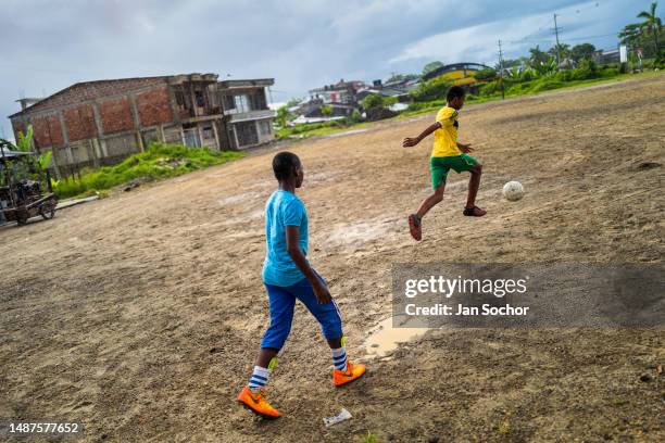 Afro-Colombian play the ball during a football training session on a dirt playing field on October 8, 2019 in Quibdó, Chocó, Colombia. Young...