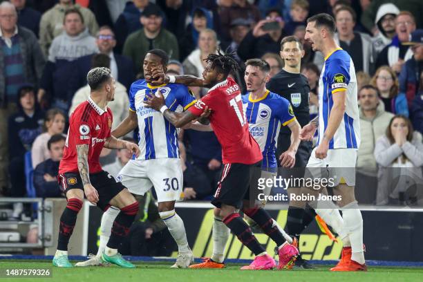 Antony of Manchester United and Lewis Dunk square up to each other before Pervis Josue Tenorio Estupinan of Brighton & Hove Albion and Fred of...