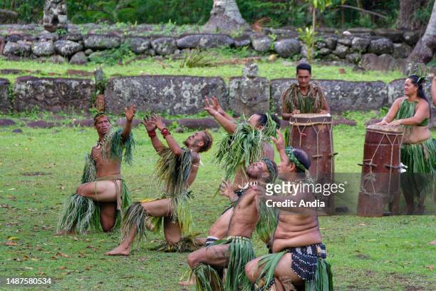 Dancers in traditional outfit performing a traditional dance in Hatiheu, Nuku Hiva, Marquesas Islands, South Pacific.