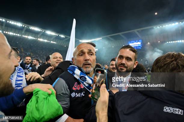 Luciano Spalletti, Head Coach of SSC Napoli, is surrounded by SSC Napoli fans on the pitch after their side wins the Seria A title after the Serie A...