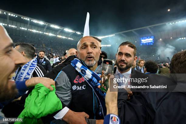 Luciano Spalletti, Head Coach of SSC Napoli, is surrounded by SSC Napoli fans on the pitch after their side wins the Seria A title after the Serie A...