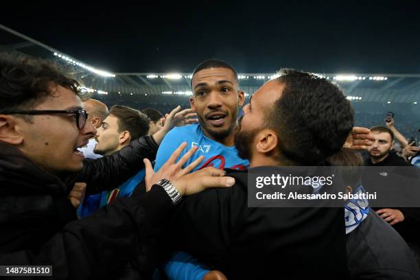 Juan Jesus of SSC Napoli, is surrounded by SSC Napoli fans on the pitch after their side wins the Seria A title after the Serie A match between...