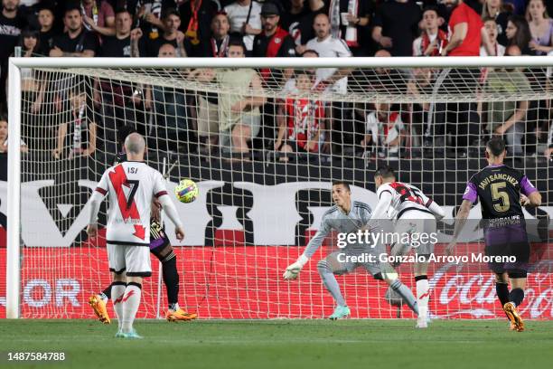 Raul de Tomas of Rayo Vallecano scores the team's first goal past Jordi Masip of Real Valladolid CF during the LaLiga Santander match between Rayo...