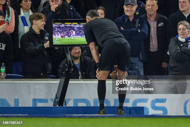 Referee Andre Marriner checks pitch side VAR monitor before he awards a penalty against Luke Shaw of Manchester United for handball during the...