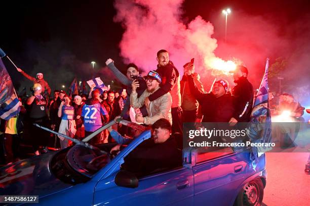 Fans of SSC Napoli celebrate with flares outside the stadium after their side winning the Serie A title after their side's draw in the Serie A match...